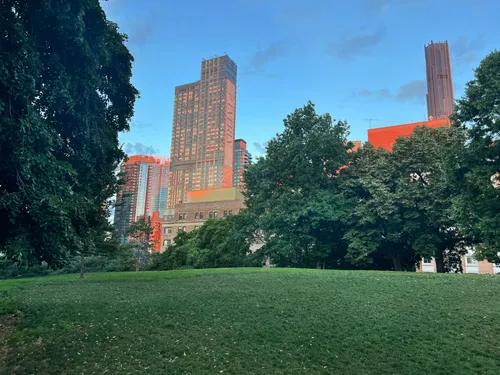 Tall residential buildings rise west of the park