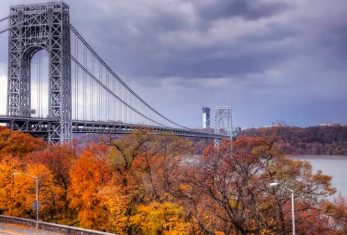 Autumn foliage frames the George Washington Bridge in golden hues