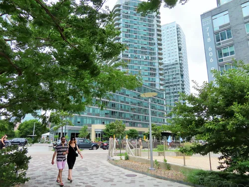 Visitors near Center Boulevard with modern high-rises behind
