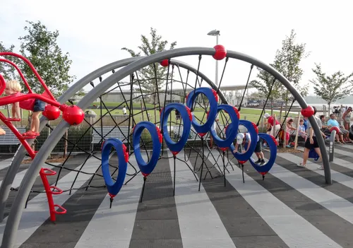 Red and blue climbing arches in the striped play area