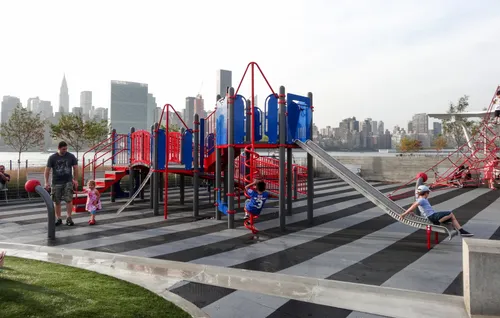 Colorful playground structures sit near the river