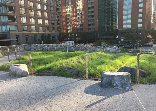 The park's stone walls and native plantings make for a stark contrast to the modern city buildings