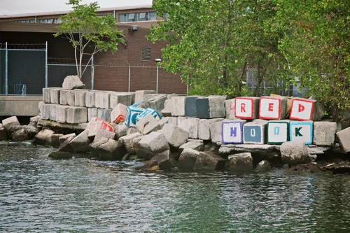 Stone blocks with letters arranged on the rocky shoreline