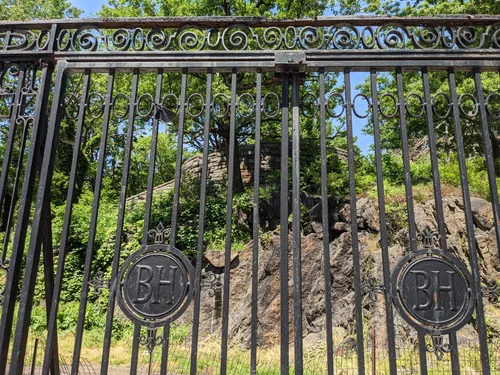 Decorative iron gate with near rocky terrain