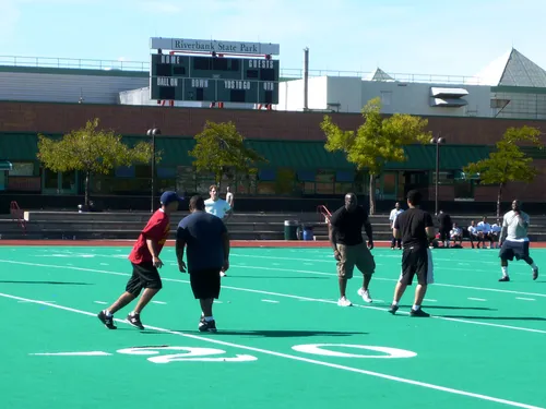 Athletes enjoy a game on the bright green turf field