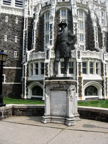 Historic statue of Alexander S. Webb stands before City College's Gothic architecture