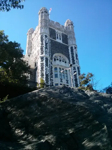 Shepard Hall tower rises majestically behind rocky outcrop