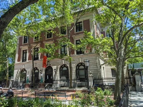 The Seward Park Library building framed by lush summer foliage