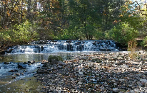 A small waterfall cascades over rocks along Allen Creek