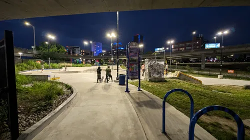 Nighttime pathway leads visitors towards Roc City Skatepark