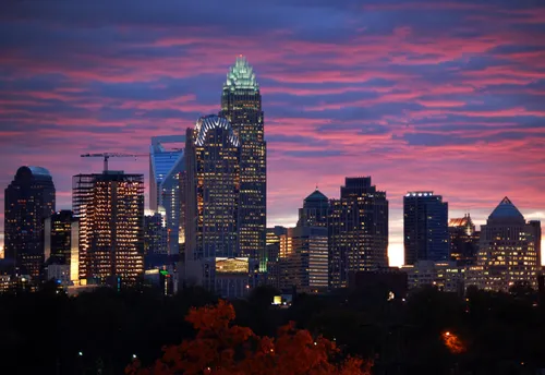 The park offers a magical view of the Charlotte skyline as it glows against a vivid purple sky