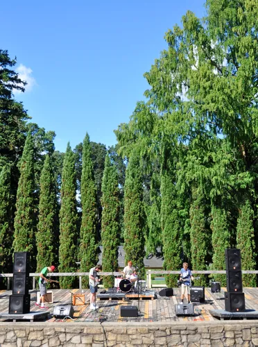 Tall cypress trees form an impressive backdrop during a music performance at the amphitheatre