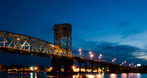 The Cape Fear Memorial Bridge lit up over the river at dusk