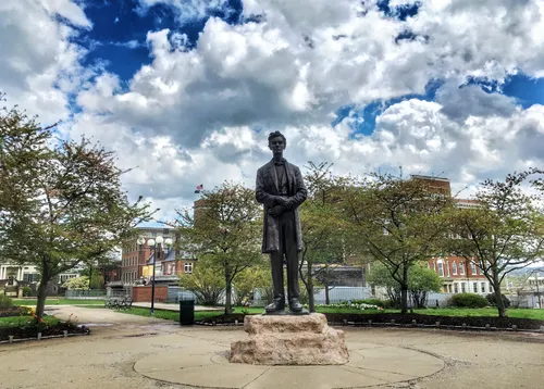 Bronze statue of Abraham Lincoln by artist George Grey Barnard under a dramatic sky