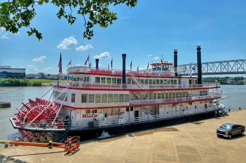 The Belle of Cincinnati riverboat docked along the Ohio River shoreline