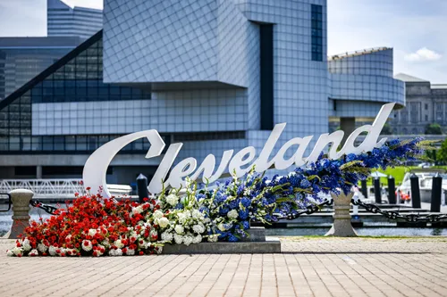 Cleveland script sign surrounded by colorful floral displays