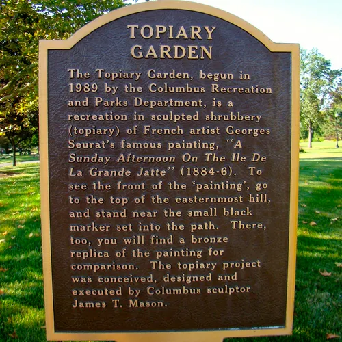 Informational plaque detailing the Topiary Garden's recreation of Seurat's famous painting
