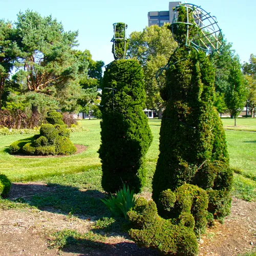 Sculpted shrubs form artistic figures in the unique topiary landscape