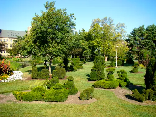 Topiary figures arranged across the lawn creating a three-dimensional artwork