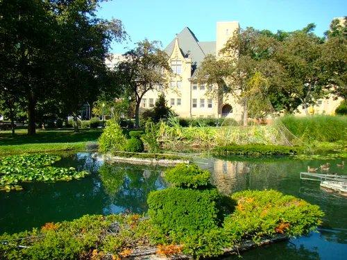 View of the pond with the surrounding park grounds