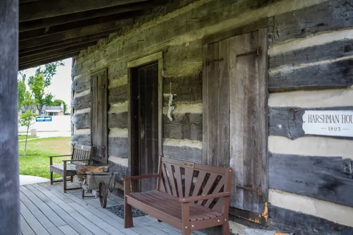 Wooden benches on the porch of a preserved pioneer building