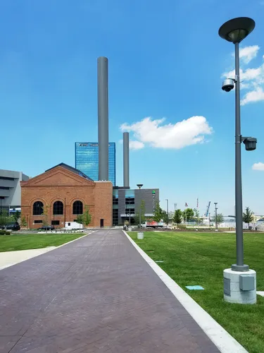 A walkway leads through the park toward the historic Edison Steam Plant