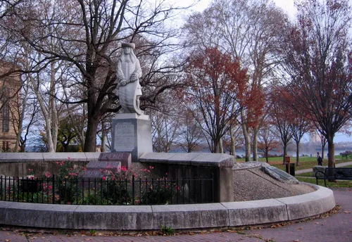 The statue of William Penn stands among autumn trees