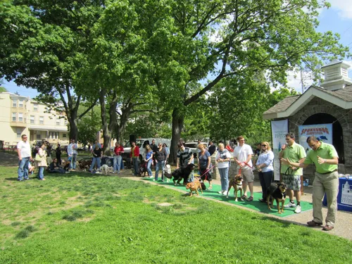 Visitors line up for an event along the green lawn