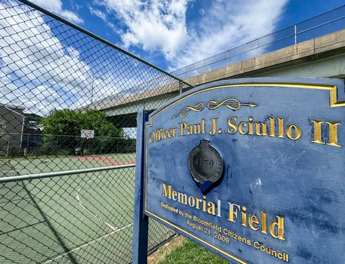 The Officer Paul J. Sciullo II Memorial Field sign next to the basketball court