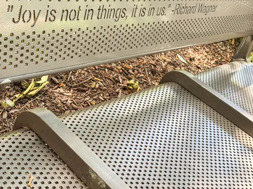 A perforated bench at the park bears a quote by Richard Wagner