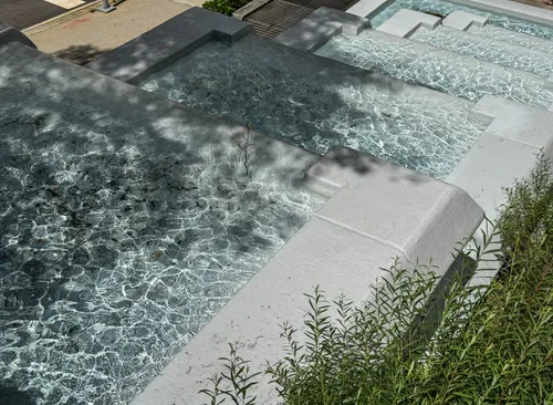 Water ripples down the cascading feature in the park's west corner