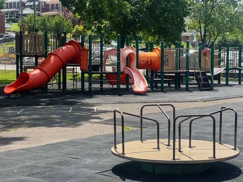 The children's playground area features slides and a merry-go-round