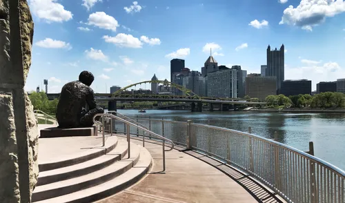 Mister Rogers sculpture overlooking Pittsburgh's skyline along the Allegheny River