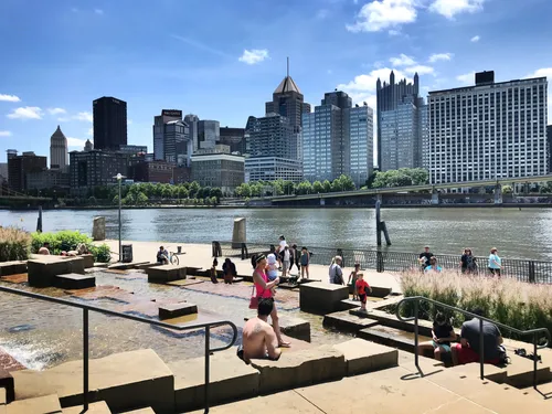 Water Steps create a playful sandstone waterscape where visitors enjoy the river view