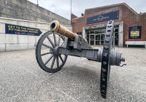 A historic cannon on display outside the Fort Pitt Museum