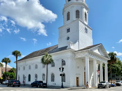 The historic St. Michael's Church with its white steeple stands across from Washington Square