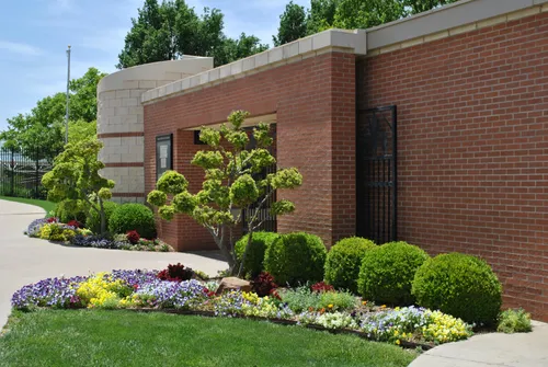 Carefully landscaped exteriors complement the brick building entrance