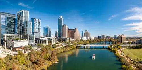 Austin's skyline rises high with parkland visible on the opposite shore