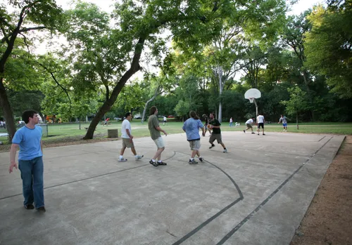 A pickup basketball game underway on the outdoor court