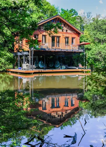 Wooden boathouse with clear reflection