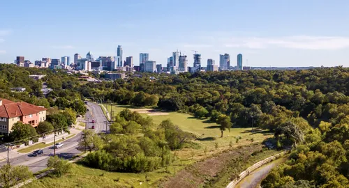 Austin skyline view from Pease District Park with its green grounds to the right