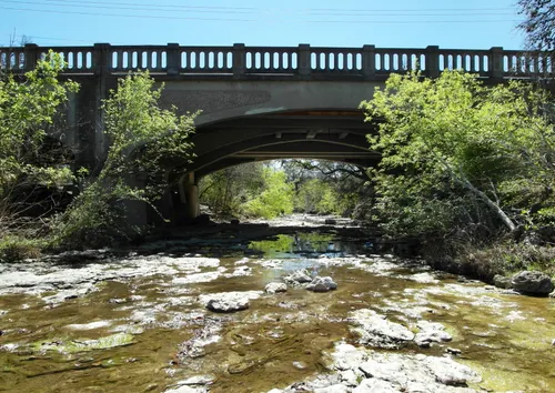 Stone bridge spanning across Shoal Creek
