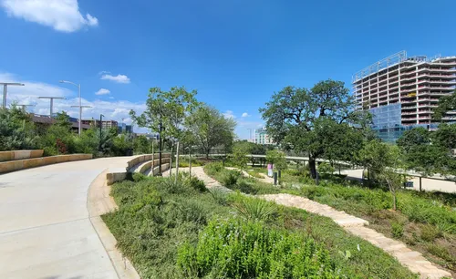 Trails pass through landscaped areas with native plantings