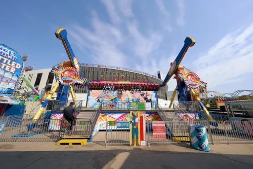 Colorful carnival rides spin at the State Fair of Texas