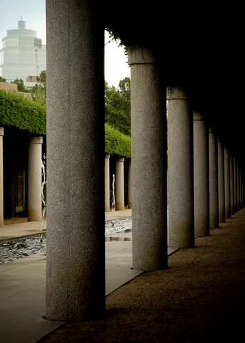 Stone columns line the shaded walkway