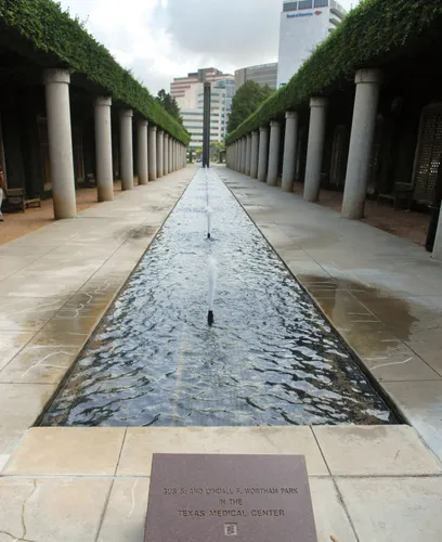 A water channel runs between two walkways with columns