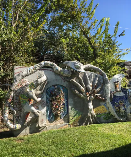 A long wall structure showcases the park's unique recycled material artistry