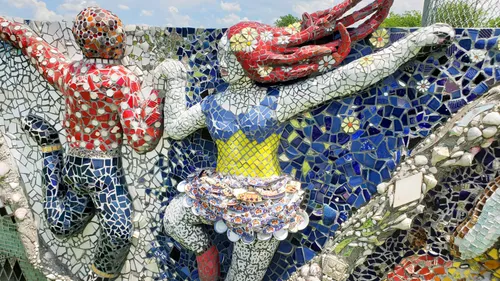 Detailed view of intricate mosaic work featuring colorful patterns and dancers