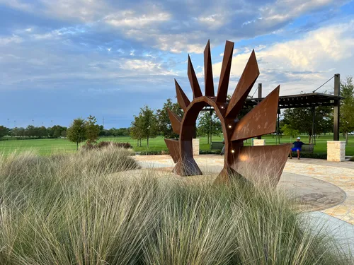 The windmill sculpture at Yonders Point behind native grasses