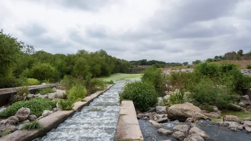 The San Antonio River flows down a stepped stone channel